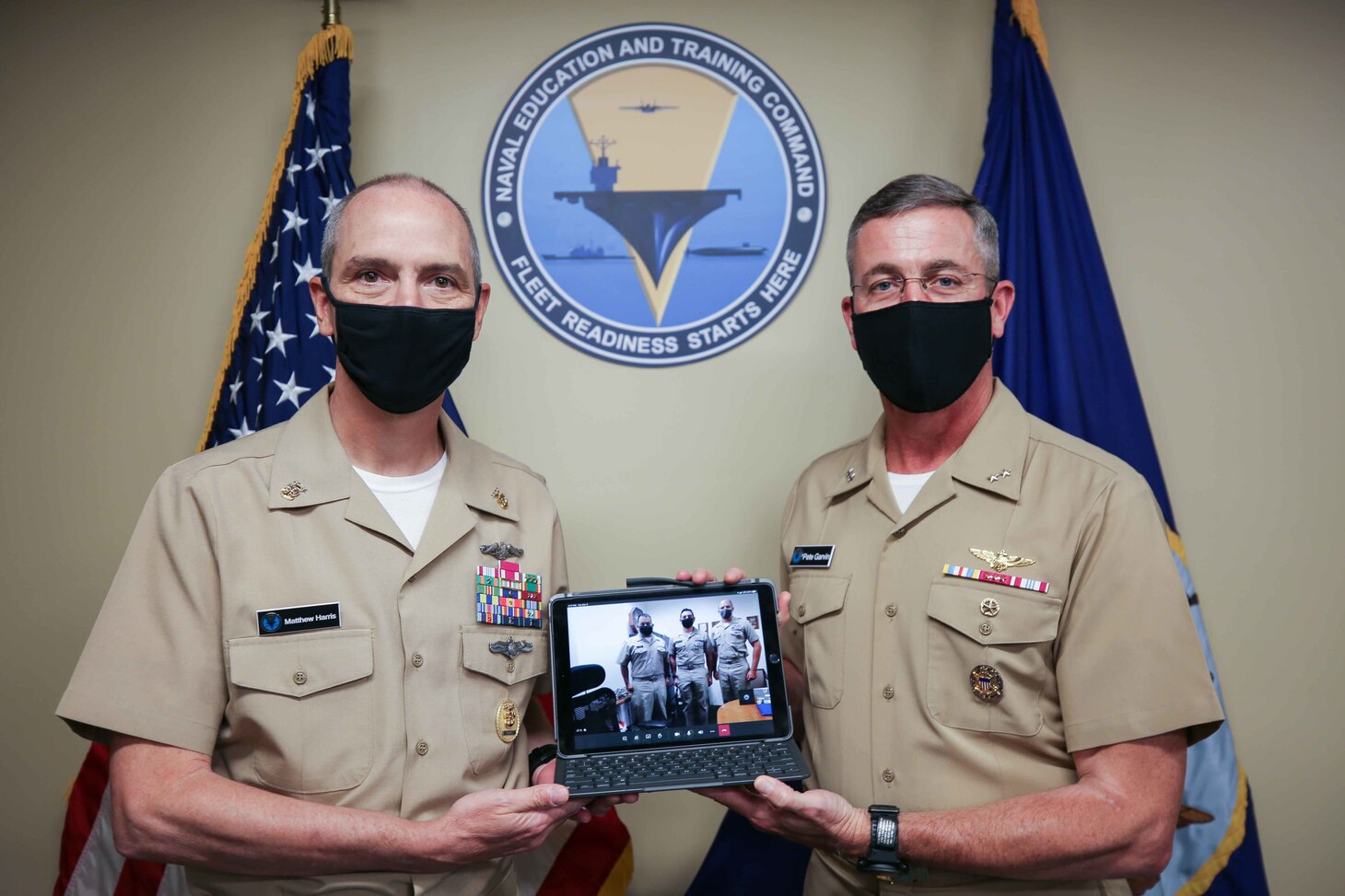 Rear Adm. Pete Garvin, commander, Naval Education and Training Command (NETC), right, and Force Master Chief Matthew Harris, recognize  Lt. Alfonso Sciacchitano, assigned to Naval Submarine Training Center Pacific Detachment, Santa Rita, Guam, as the 2020 MyNavy HR Force Development domain officer military instructor of the year (MIOY). The NETC MIOY program recognizes Sailors throughout the domain who exhibit attributes, such as sustained superior performance, leadership, mentorship, knowledge and teaching of military history and heritage, self-improvement, command and community involvement, and exemplary military bearing. (U.S. Navy photo by Genevieve McGee)