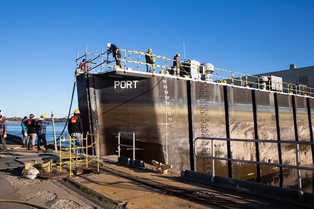 Code 992 prepare to remove the caisson from Dry Dock 8 for the arrival of a U.S. Navy vessel.