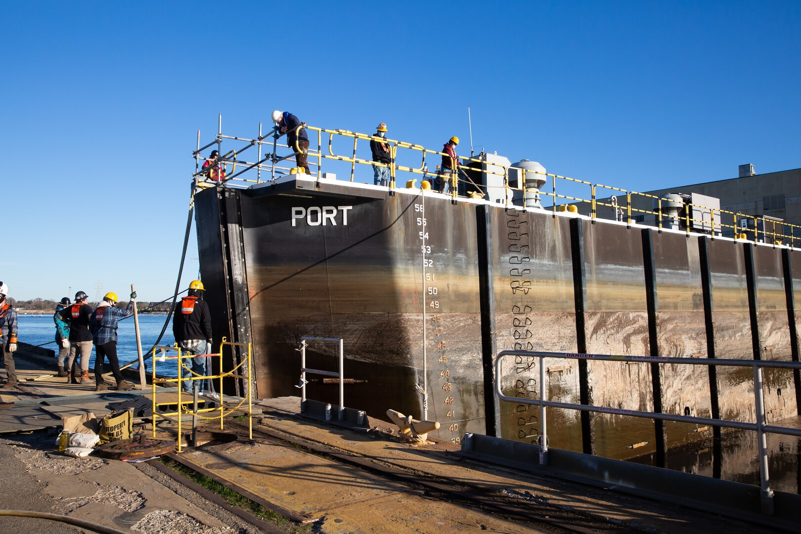 Code 992 prepare to remove the caisson from Dry Dock 8 for the arrival of a U.S. Navy vessel.