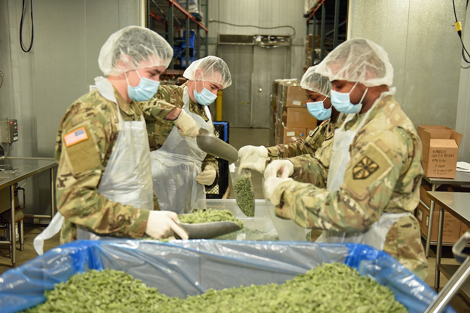 Michigan National Guard Soldiers with Michigan’s Task Force Spartan work with Gleaners of Warren, Michigan, Community Food Bank, Nov. 24, 2020. Army and Air National Guard members filled and labeled dry and frozen green bean bags and cold and dry food boxes, reaching a goal of 90,000 lbs. during the Thanksgiving holiday week.