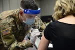 Oregon Army National Guard Sgt. Ryan Kill administers the COVID-19 vaccine to a walk-in patient at the Oregon Convention Center, Portland, Ore., Jan. 27, 2021. Guard members are helping local partners throughout the state respond to the pandemic.