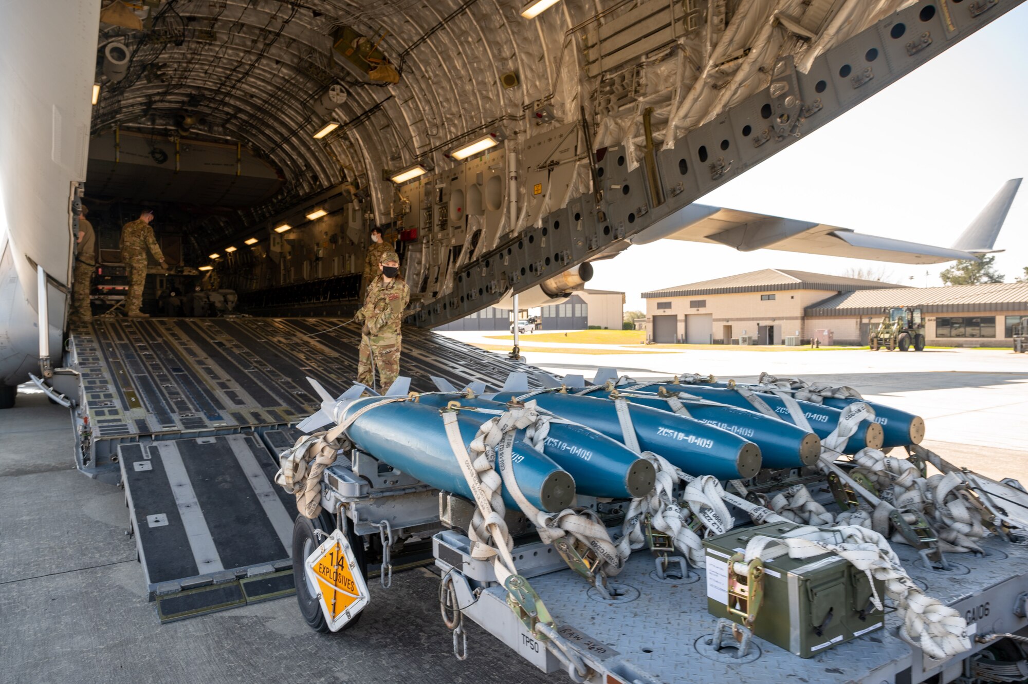 Inert training bombs are being loaded onto a Dover Air Force Base C-17 Globemaster III during exercise Mosaic Tiger at Moody AFB, Georgia, Feb. 25, 2021. Multi-capable mobility Airmen participated in the exercise led by the 23rd Wing at Moody AFB, Georgia, to enhance readiness and reinforce Air Mobility Command support to the joint warfighter. (U.S. Air Force photo by Airman 1st Class Faith Schaefer)