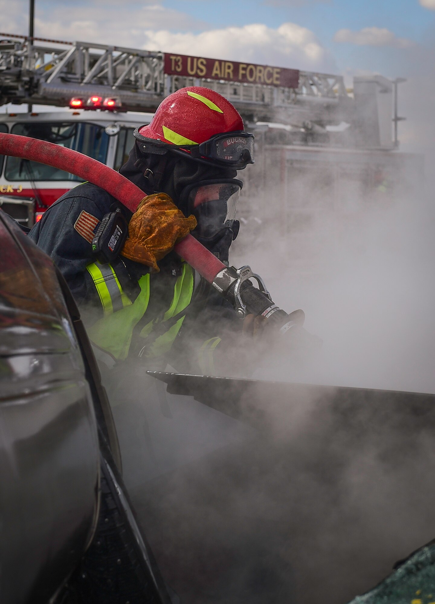 Fire Lt. Christopher Debaca, a firefighter with the 460th Civil Engineer Squadron, hoses down a burning vehicle during an auto extraction exercise on Buckley Air Force Base, Colo., Feb. 24, 2021.