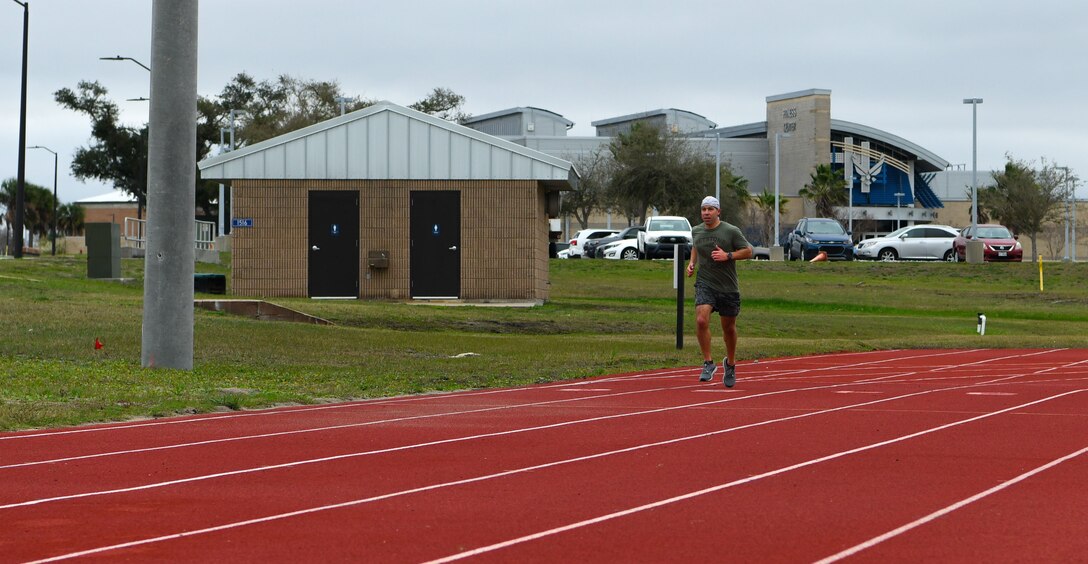 Man runs on track.