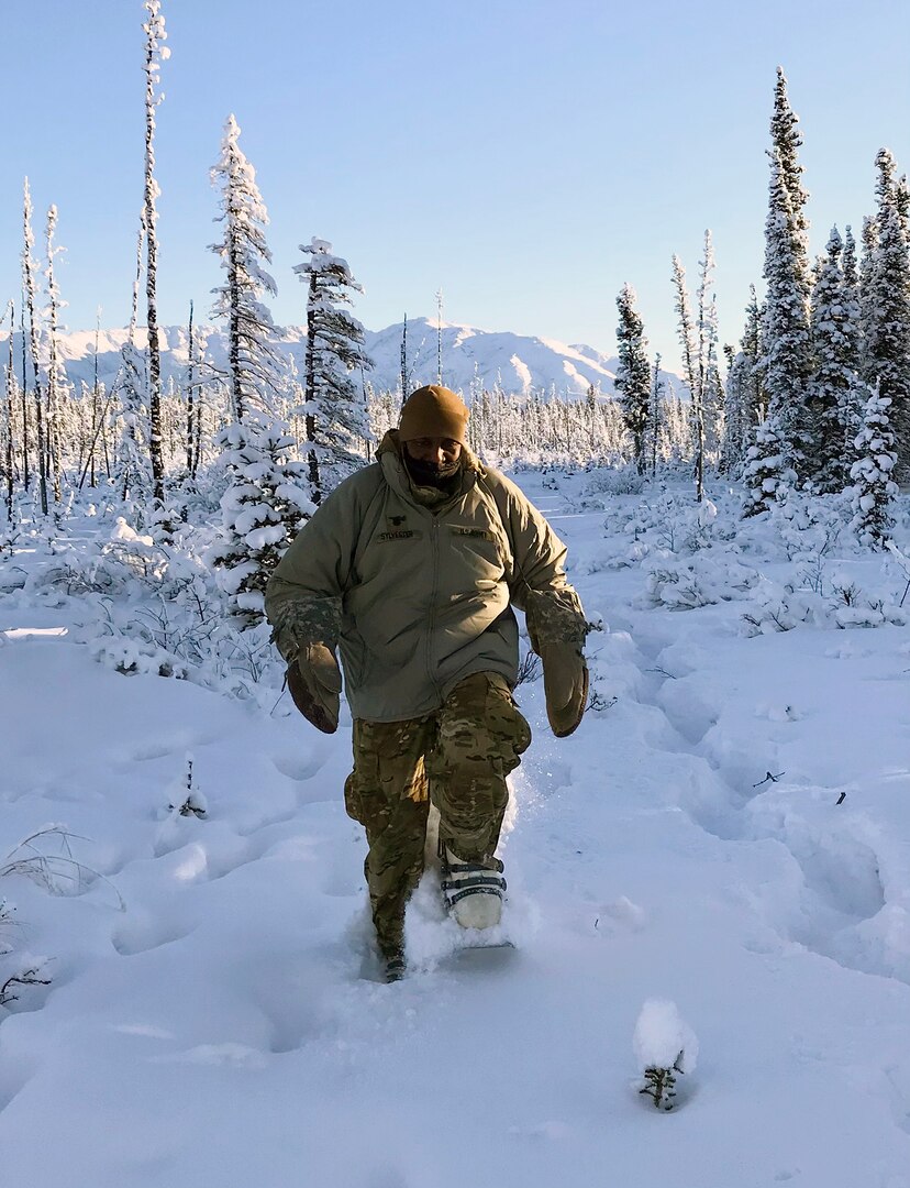 Lt. Col. Cleve Sylvester, a member of the Army Capability Manager-Army Health System team, uses Army-issued snowshoes to maneuver in the training area during support of Arctic Warrior 2021 at Fort Greely, Alaska.