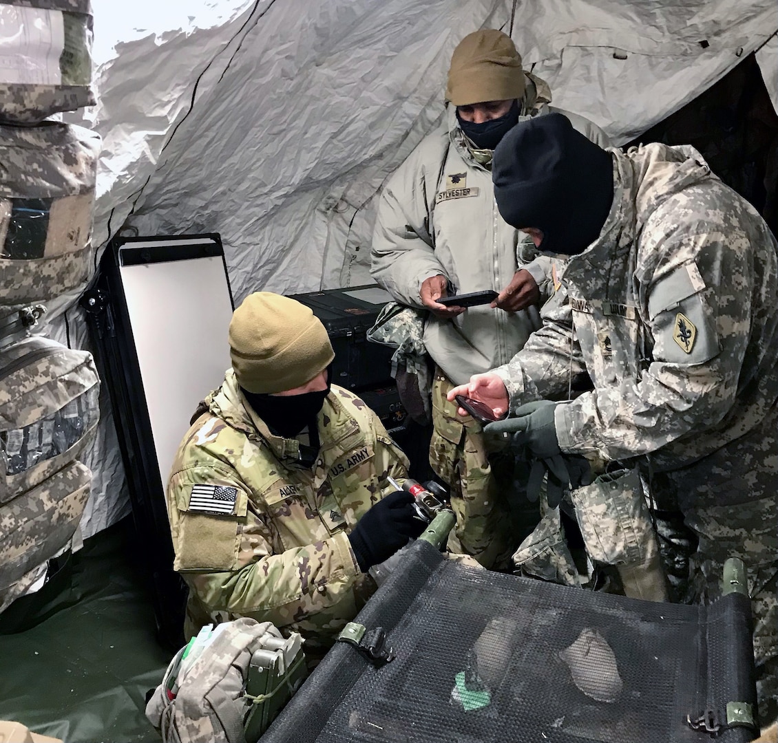 (From left): A medic from 4th Brigade 25th Infantry Division; Lt. Col. Cleve Sylvester; and Master Sgt. David Edwards assessing CLVIII at Role 1 in support of Arctic Warrior 2021 at Fort Greely, Alaska.
