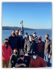 Naval Surface Warfare Center, Carderock and Philadelphia Division employees take a group photo on the bow of USS Zumwalt (DDG 1000) while in port on Nov. 8, 2020 in Everett, Washington.