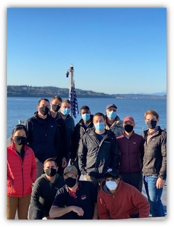 Naval Surface Warfare Center, Carderock and Philadelphia Division employees take a group photo on the bow of USS Zumwalt (DDG 1000) while in port on Nov. 8, 2020 in Everett, Washington.