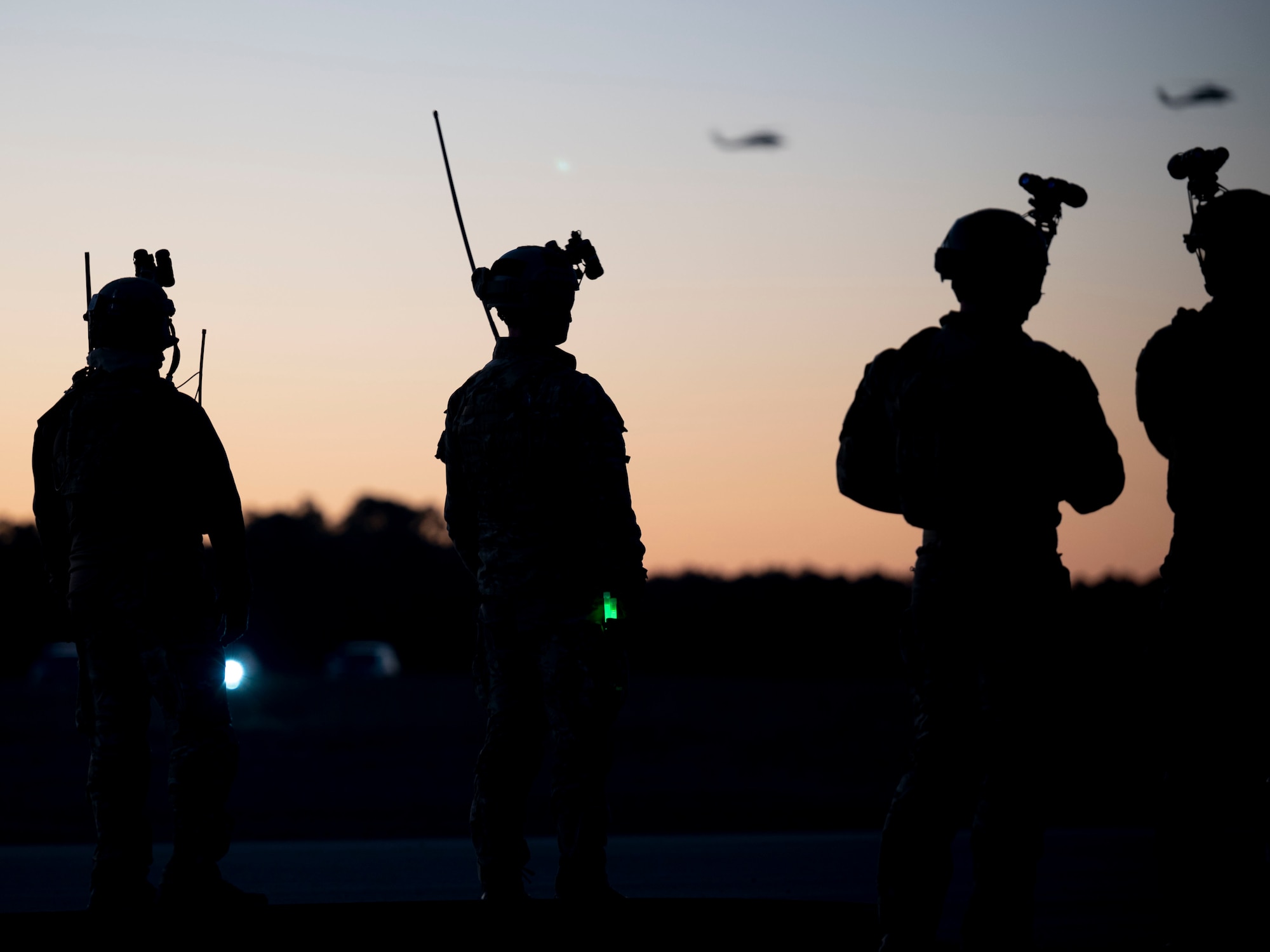 U.S. Air Force Special Tactics operators, assigned to the 24th Special Operations Wing, and forward area refueling point members, assigned to the 1st Special Operations Logistics Readiness Squadron, coordinate with U.S. Navy MH-60 Seahawk Helicopters, assigned to Helicopter Sea Combat Squadron 9 and an MC-130H assigned to the 15th Special Operations Squadron, to establish a FARP location during Emerald Warrior 21.1, at Hurlburt Field, Florida, Feb. 20, 2021. Emerald Warrior is the largest joint special operations exercise involving U.S. Special Operations Command forces training to respond to various threats across the spectrum of conflict. (U.S. Air Force photo by Senior Airman Edward Coddington)