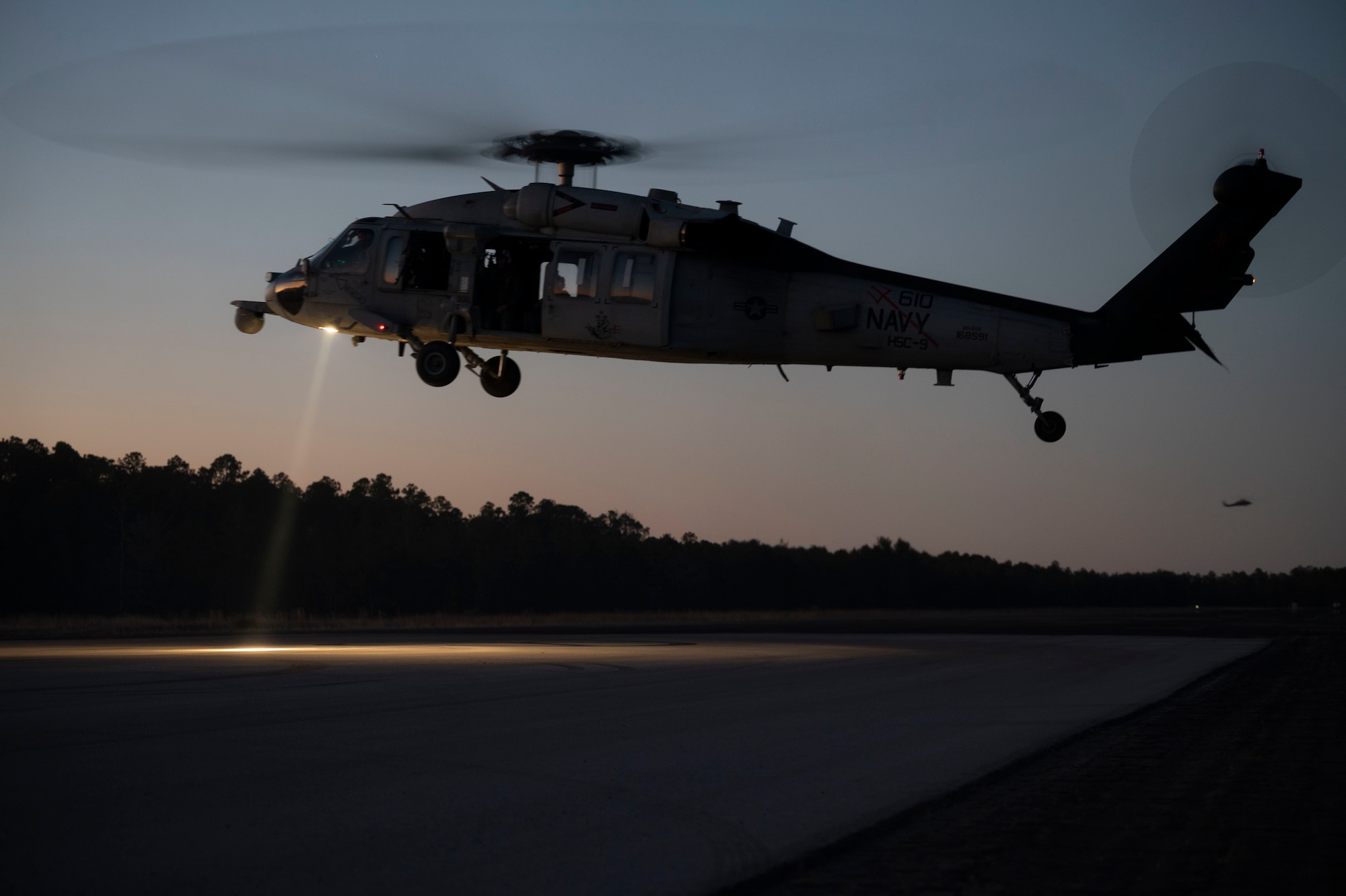 A U.S. Navy MH-60 Seahawk Helicopter, assigned to Helicopter Sea Combat Squadron 9, prepares to land at a forward area refueling point during Emerald Warrior 21.1, at Hurlburt Field, Florida, Feb. 20, 2021. Emerald Warrior is the largest joint special operations exercise involving U.S. Special Operations Command forces training to respond to various threats across the spectrum of conflict. Exercises like EW give theater commanders the assurance SOF forces can respond quickly — on time, every time. (U.S. Air Force photo by Senior Airman Edward Coddington)