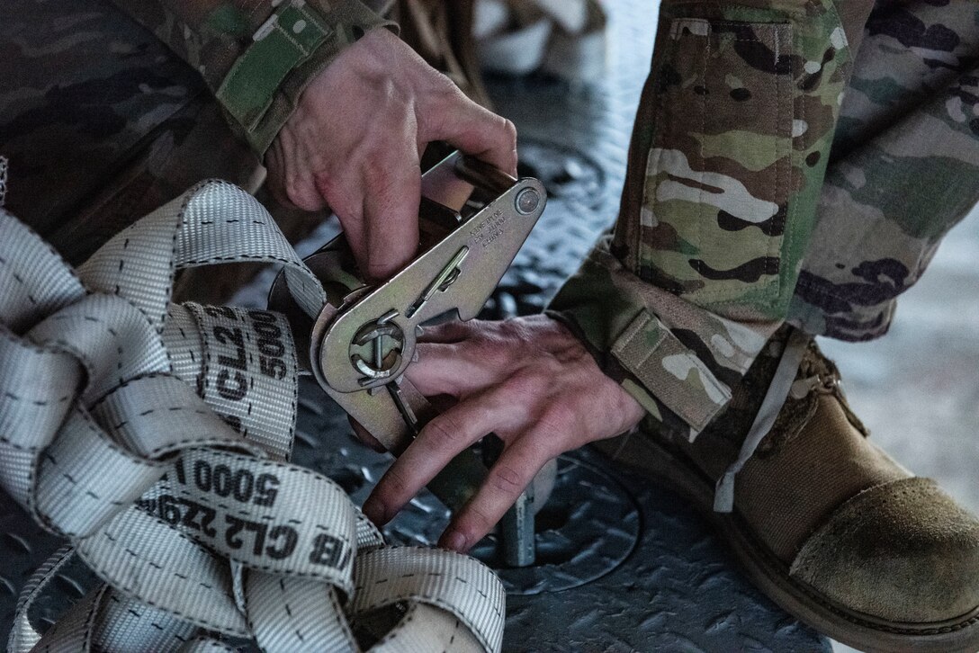 Photo of an Airman releasing a strap
