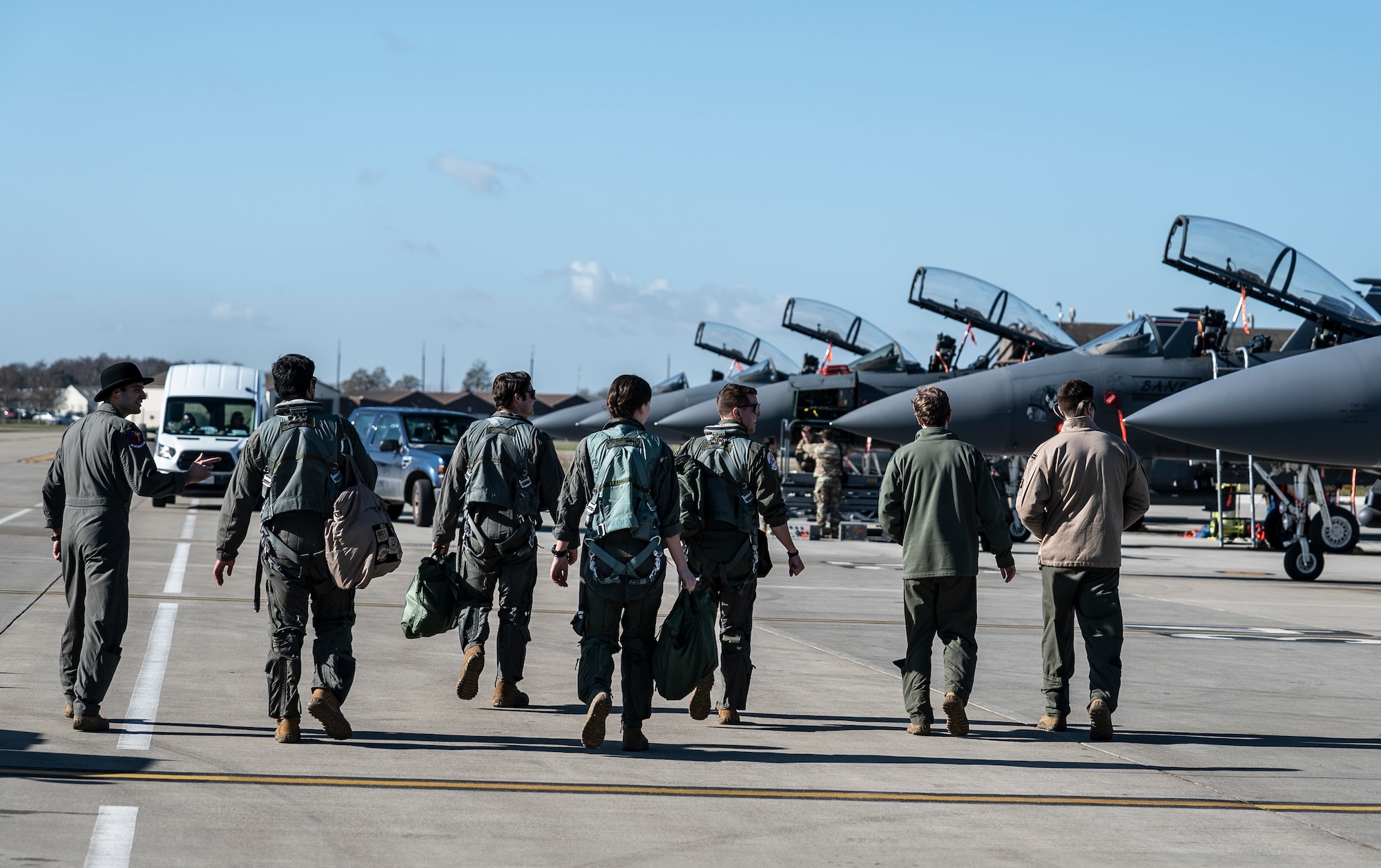 Aircrew assigned to the 492nd Fighter Squadron, along with Airmen who have been awarded orientation flights, step to their aircraft at Royal Air Force Lakenheath, England, Feb. 26, 2021. Orientation flights are offered to those who have responsibilities related to aviation and aircraft or as an award to individuals who show exceptional performance in their duties. (U.S. Air Force photo by Airman 1st Class Jessi Monte)