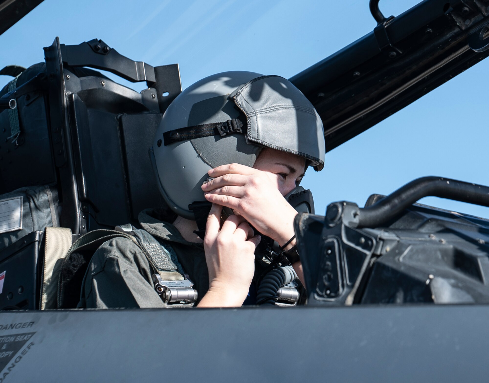 U.S. Air Force Senior Airman Olivia Gavin, 48th Operations Support Squadron target analyst, attaches her oxygen mask prior to an orientation flight in an F-15E Strike Eagle at Royal Air Force Lakenheath, England, Feb. 26, 2021. Orientation flights are offered to those who have responsibilities related to aviation and aircraft or as an award to individuals who show exceptional performance in their duties. (U.S. Air Force photo by Airman 1st Class Jessi Monte)