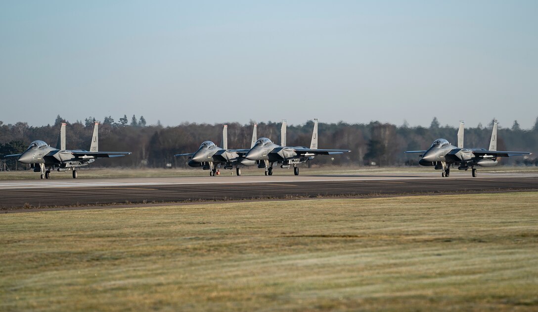 F-15E Strike Eagles line up on the runway for the first wave of orientation flight take-offs at Royal Air Force Lakenheath, England, Feb. 26, 2021. Orientation flights are offered to those who have responsibilities related to aviation and aircraft or as an award to individuals who show exceptional performance in their duties. (U.S. Air Force photo by Airman 1st Class Jessi Monte)