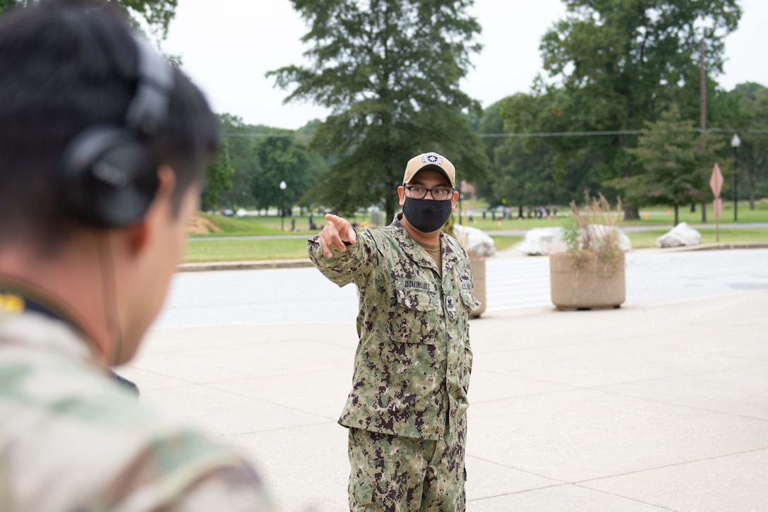 Students and instructors conduct camera training outside the Defense Information School.