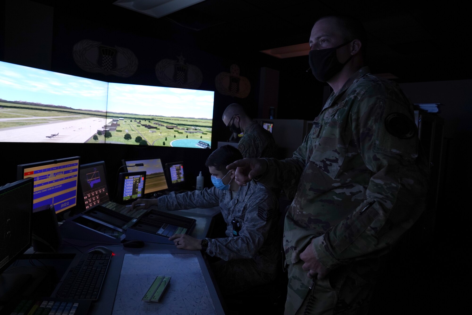 U.S. Air Force Tech. Sgts. Dereck Padgett, Kyle Hayes, and Dustin Brannan, 334th Training Squadron air traffic control instructors, practice air traffic simulations inside Cody Hall at Keesler Air Force, Mississippi, March 4, 2020. The instructors were selected to be a part of the Air Education and Training Command Air Traffic Control Rapid Response Team, initiated to combat the potential loss of manning due to COVID-19. (U.S. Air Force photo by Senior Airman Seth Haddix)
