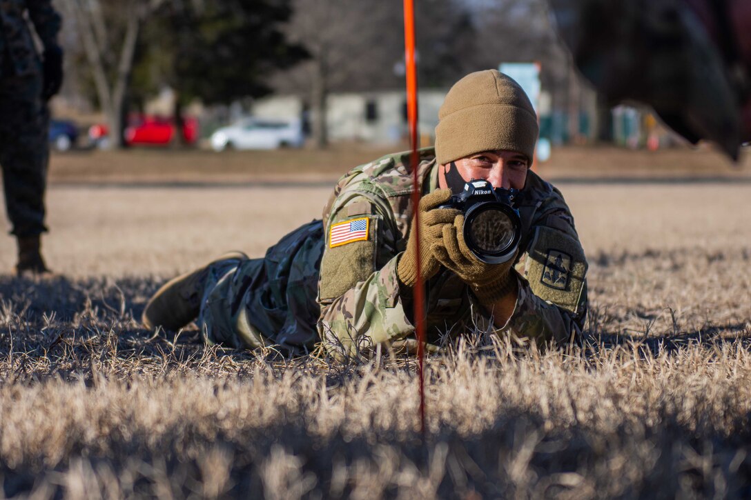 Students practice uncontrolled action photography outside the Defense Information School.