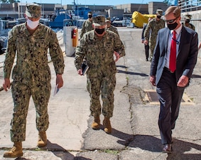 PANAMA CITY, Fla. (Mar. 4, 2021) – Capt. David Back (left), commanding officer at Naval Surface Warfare Center Panama City Division (NSWC PCD) and Dr. Peter Adair (right), NSWC PCD technical director provide a tour of unmanned systems with Adm. Mike Gilday, Chief of Naval Operations (center) March 4. (U.S. Navy Photo by Anthony Powers)