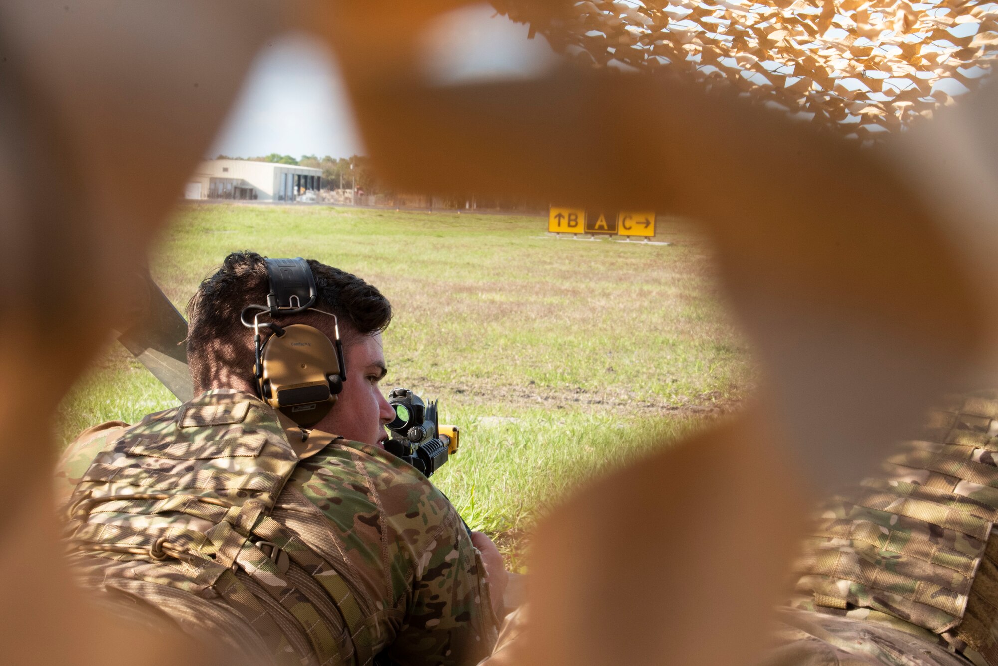 Photo of an Airman securing a defensive fighting position