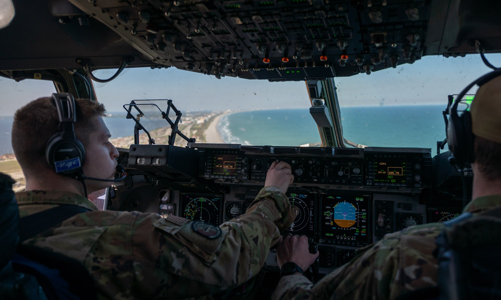 First Lt. August Hein (left) and Capt. Reed Fleming, both 3rd Airlift Squadron pilots from Dover Air Force Base fly a Dover AFB C-17 Globemaster III over Florida during Exercise Mosaic Tiger, Feb. 25, 2021. Mobility Airmen from Dover AFB and Joint Base McGuire-Dix-Lakehurst, New Jersey, participated in the exercise to enhance readiness and reinforce Air Mobility Command support to the joint warfighter. (U.S. Air Force photo by Airman 1st Class Faith Schaefer)