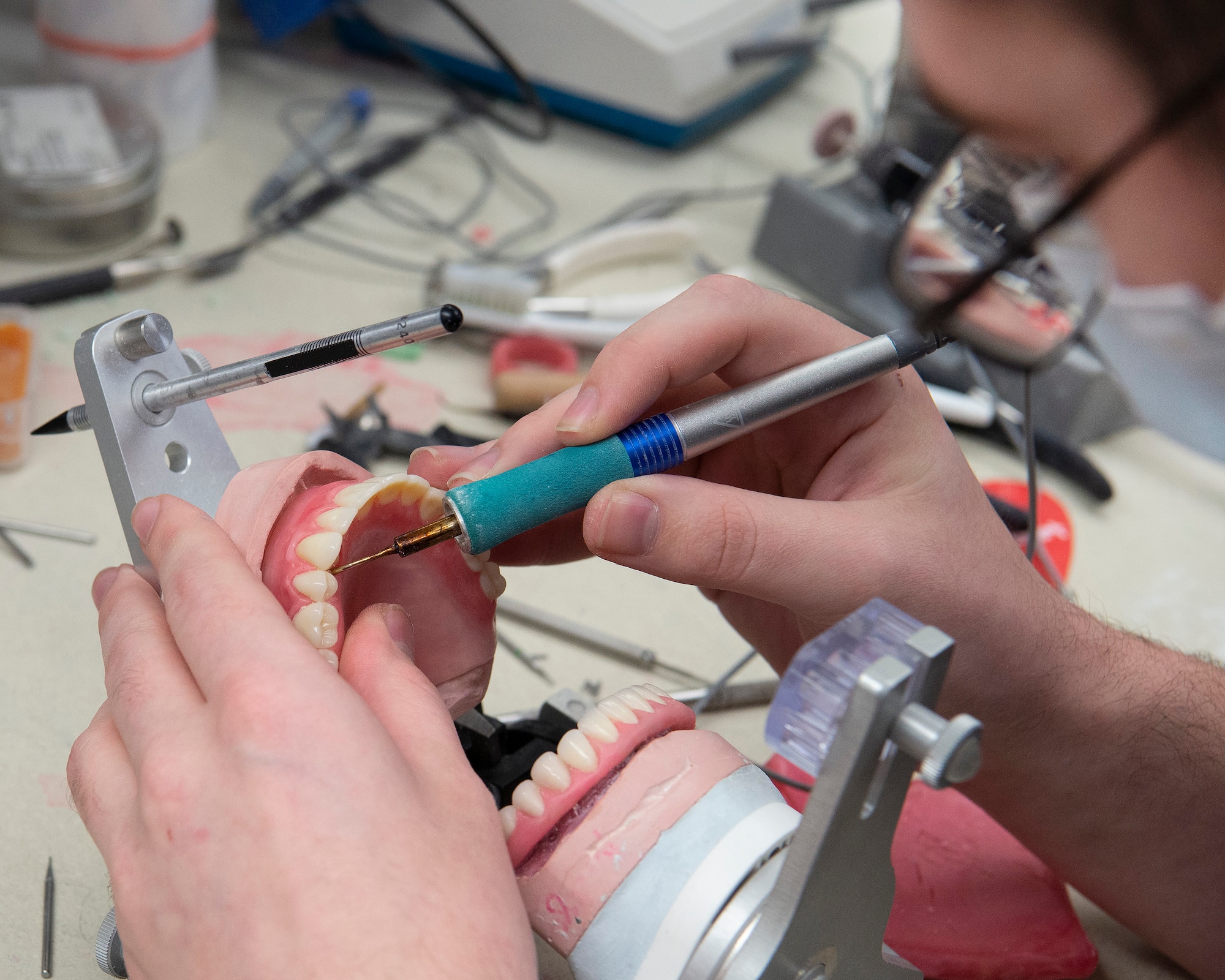U.S. Air Force Senior Airman Nicholas Carter, 88th Dental Squadron dental laboratory technician, creates a set of dentures Feb. 22, 2021, in the dental clinic lab at Wright-Patterson Air Force Base, Ohio. Carter and other technicians make the prosthetics ordered by the clinic’s dentists . (U.S. Air Force photo by R.J. Oriez)