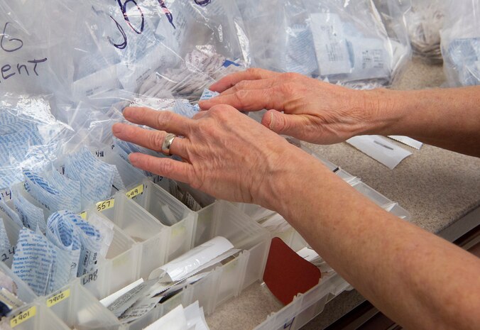 Kathy Calhoun, 88th Dental Squadron, sorts through dental burs Feb. 22, 2021, in the dental clinic at Wright-Patterson Air Force Base, Ohio. Calhoun came to work for the Wright-Patt clinic after 32 years in the private sector. (U.S. Air Force photo by R.J. Oriez )