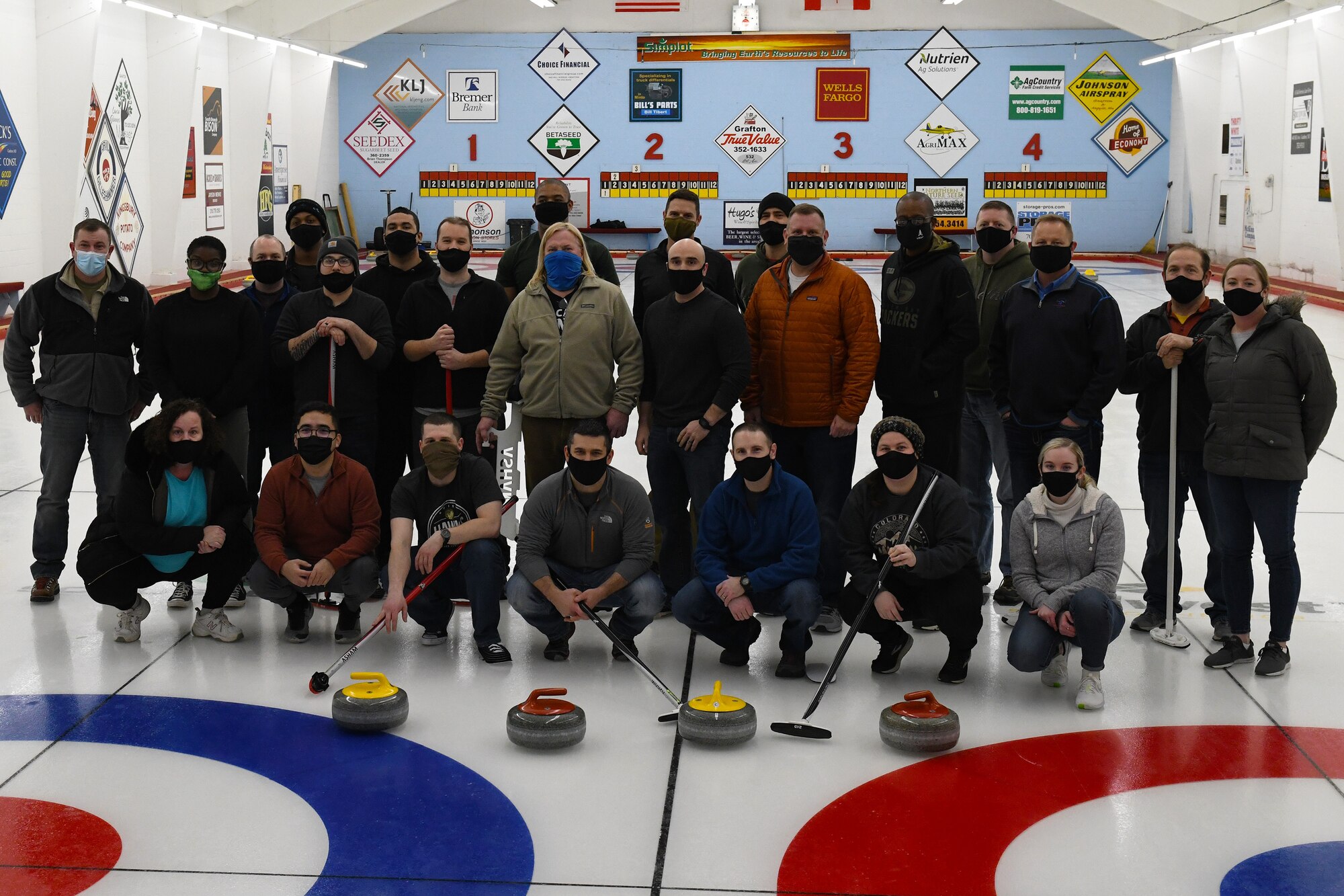 U.S. Space Force Space Delta 4 leadership and members from the 10th Space Warning Squadron team join together and visit the base's local curling club at Grafton, N.D., Feb. 22, 2021. The team was taught different curling techniques and learned the local curling club's history. (U.S. Space Force photo by Airman 1st Class Andrew Garavito)