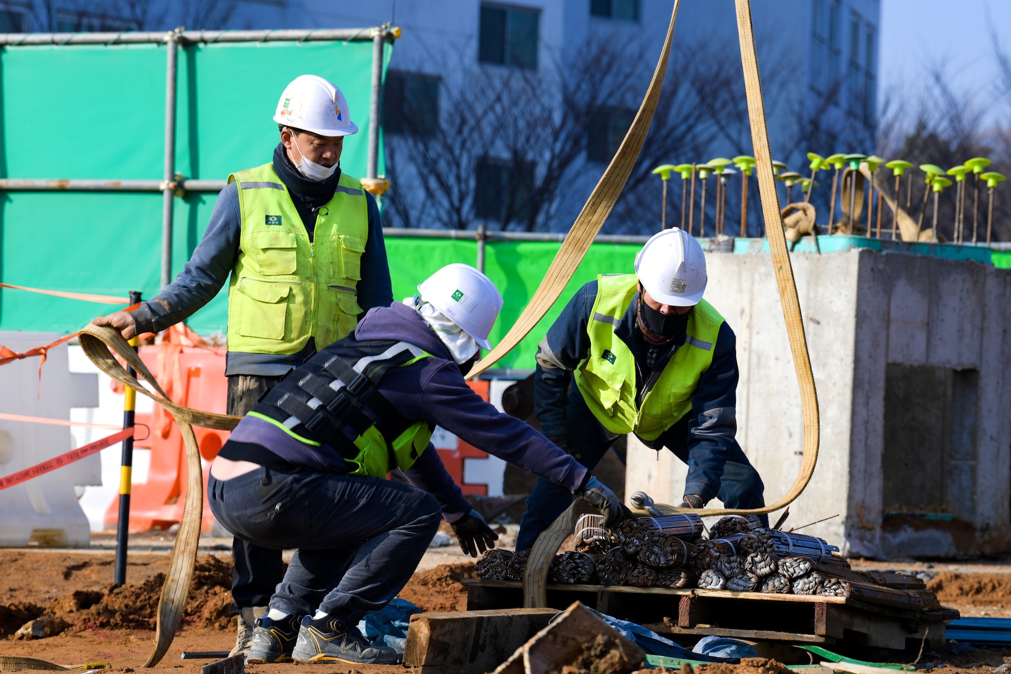 Local construction workers begin teardown of the main gate at Osan Air Base, Republic of Korea March 5, 2021. The old structures were removed in order for the newly renovated gate, due to be completed by October. (U.S. Air Force photo by Senior Airman Noah Sudolcan)