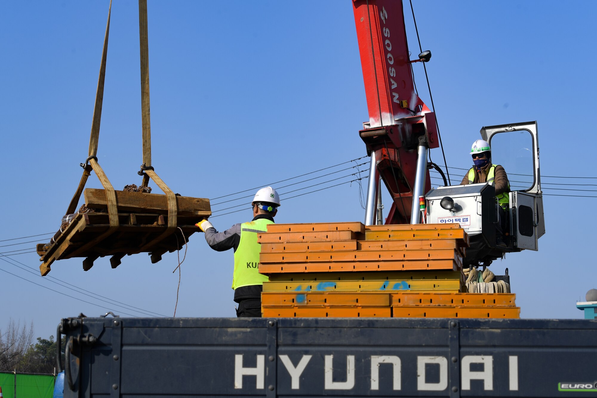 Local construction workers begin teardown of the main gate at Osan Air Base, Republic of Korea March 5, 2021. The old structures were removed in order for the newly renovated gate, due to be completed by October. (U.S. Air Force photo by Senior Airman Noah Sudolcan)