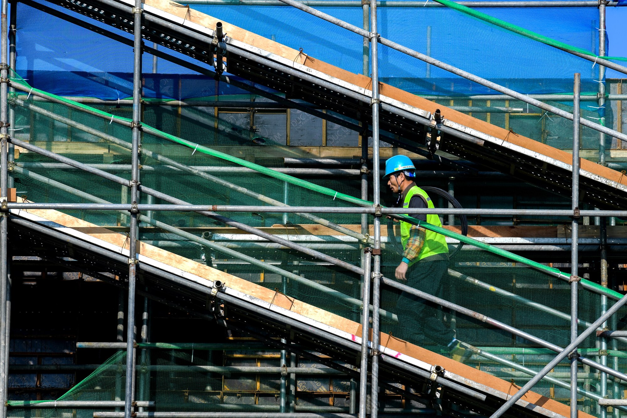 Local construction workers begin teardown of the main gate at Osan Air Base, Republic of Korea March 5, 2021. The old structures were removed in order for the newly renovated gate, due to be completed by October. (U.S. Air Force photo by Senior Airman Noah Sudolcan)
