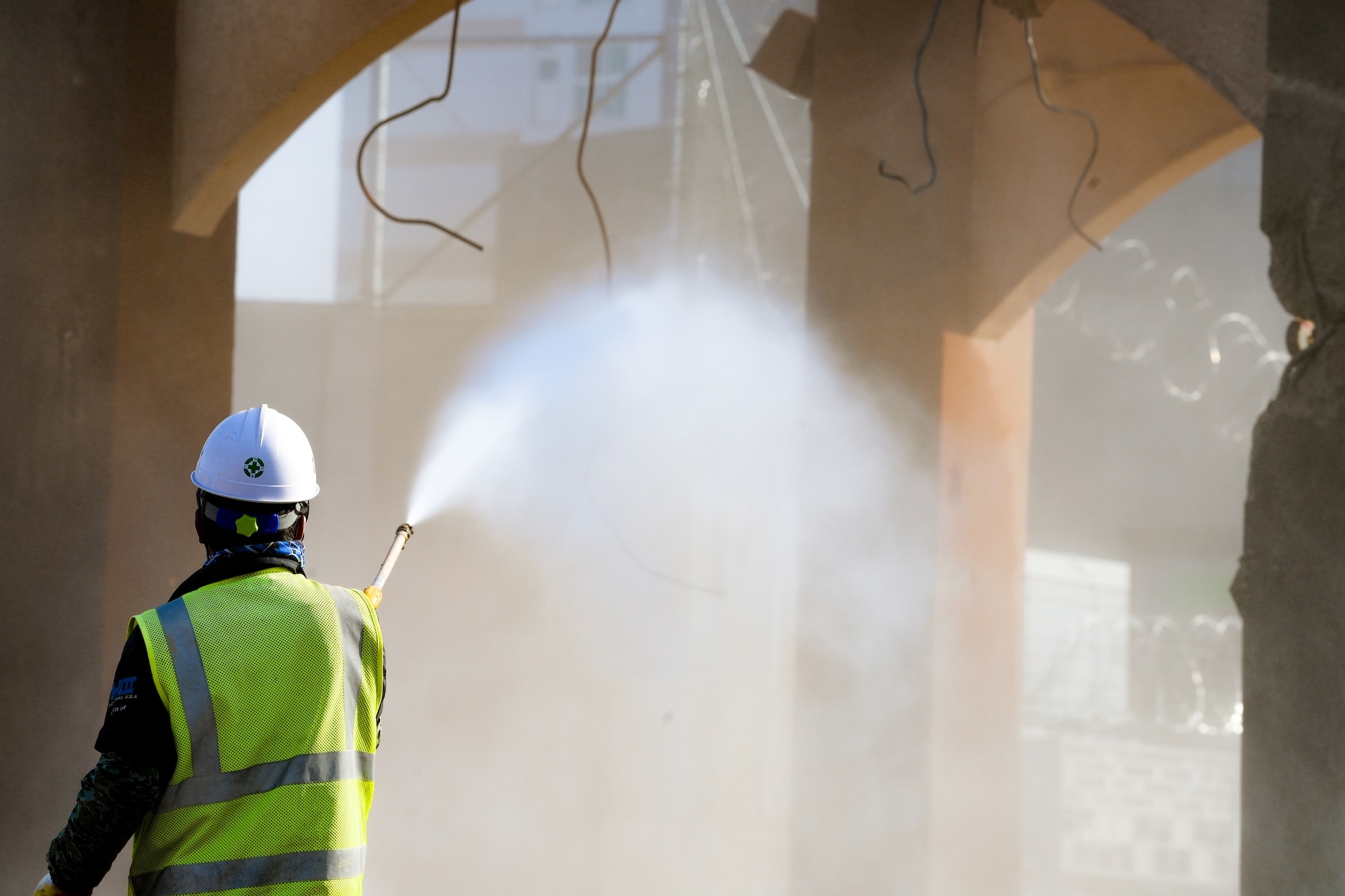 A local construction worker uses a pressure washer at Osan Air Base, Republic of Korea March 5, 2021. Pressure washing reduces the amount of dust in the air during construction. (U.S. Air Force photo by Senior Airman Noah Sudolcan)