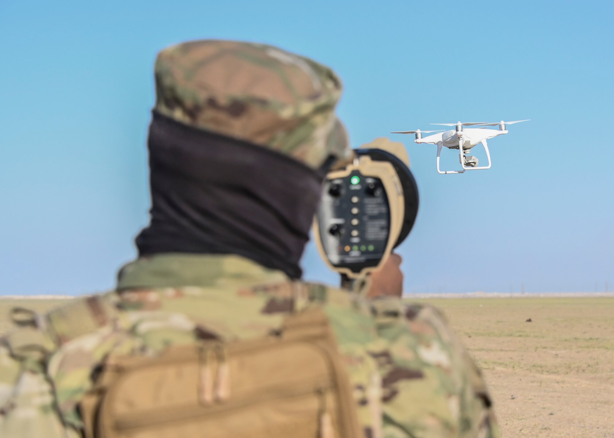 A photo of an Airman and a drone