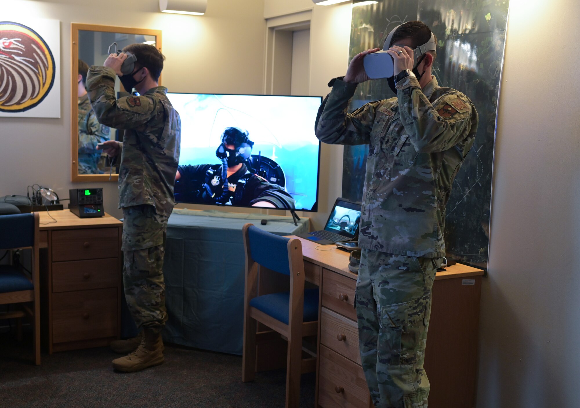 U.S. Air Force Lt. Col. Tyler Johnson, 14th Civil Engineer Squadron commander (Right), and 2nd Lt. Connor Spencer, 14th Student Squadron student pilot, test out a virtual reality training system recently installed for student pilots, Feb. 12, 2021, on Columbus Air Force Base, Miss. Student pilots assigned to the Specialized Undergraduate Pilot Training program will have 24 hour access to the training resources as part of the first step in a long term innovation and resource utilization plan. (U.S. Air Force photo by Senior Airman Jake Jacobsen)