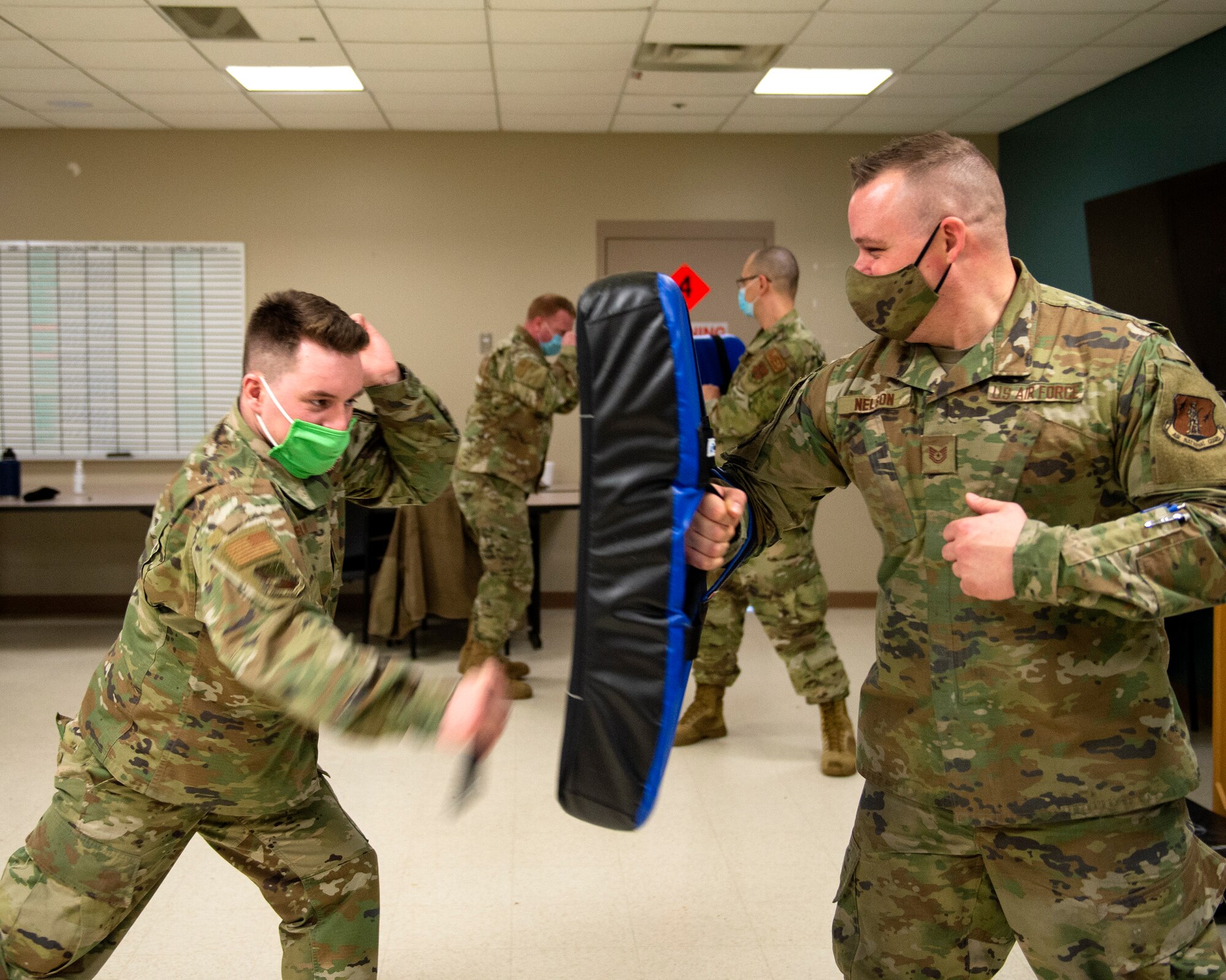 U.S. Air Force Airmen from the 133rd Airlift Wing learn the proper way to use an a collapsible baton in St. Paul, Minn., Feb. 24, 2021. The Airmen are taking part in the annual security augmentee training program, which equips base personnel with the fundamentals skills required to assist Security Forces if called upon.