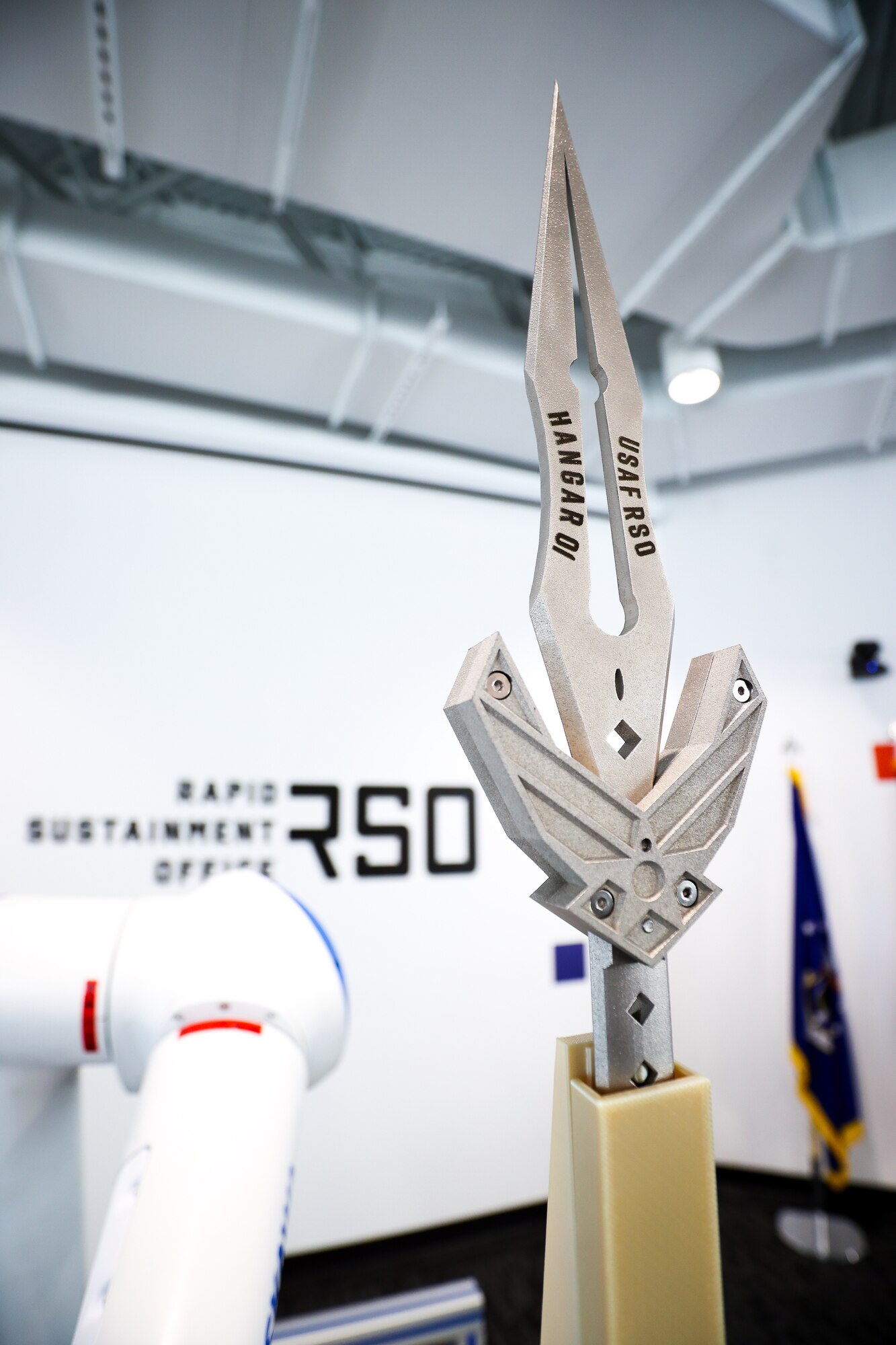 A robotic arm wielding a 3D-printed dagger cut the ceremonial ribbon as the Rapid Sustainment Office officially launched its new headquarters, Hangar 01, on March 2. (U.S. Air Force photo by Casey Tromp).