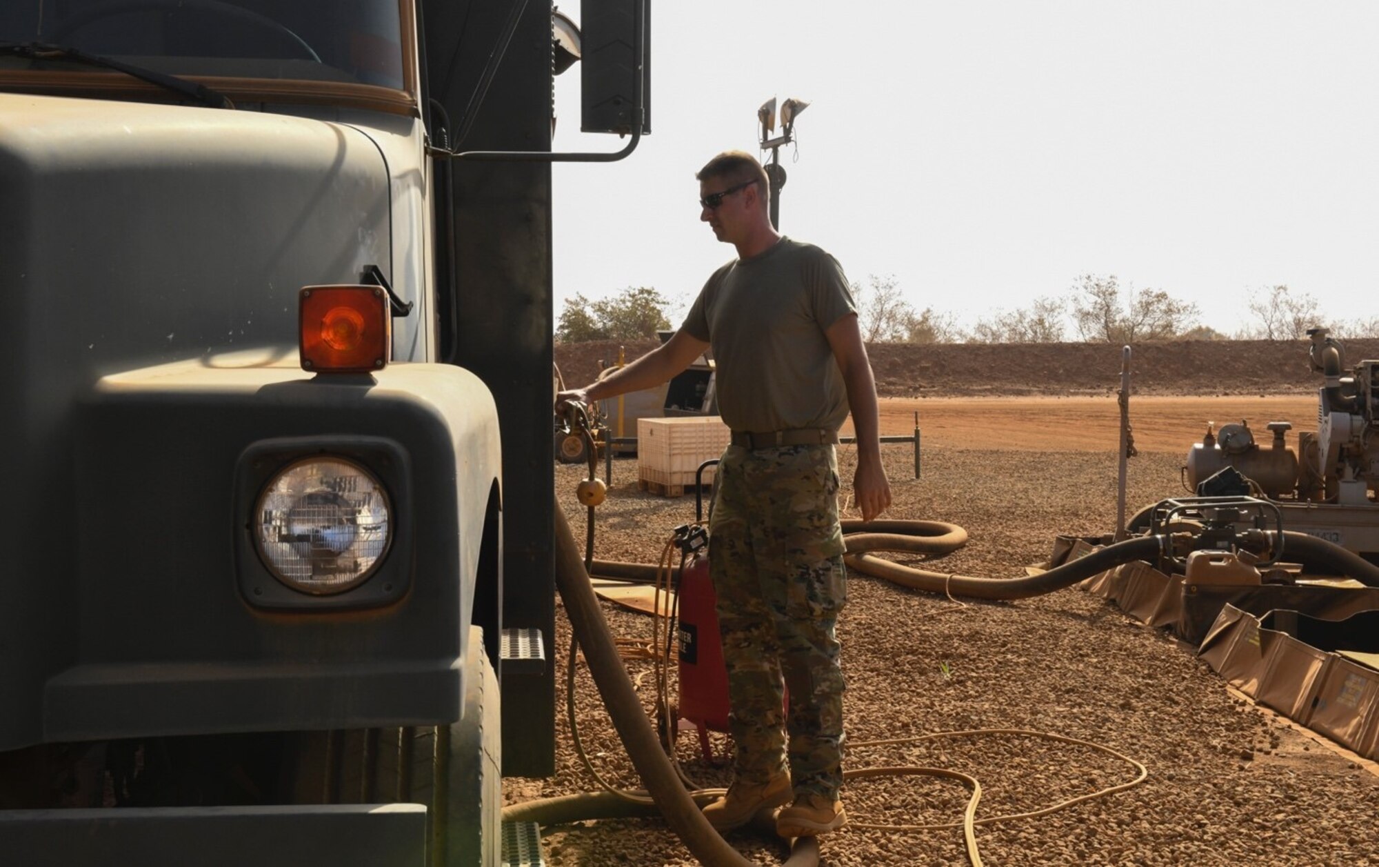 U.S. Air Force Staff Sgt. Mathew Stahl, 768th Expeditionary Air Base Squadron fuels management section chief, opens the valves of an R-11 fuel truck in preparation to transfer fuel at Nigerien Air Base 101, Niamey, Niger, Feb. 15, 2021. The R-11 fuel truck can hold up to 6,000 gallons of fuel. (U.S. Air Force photo by Senior Airman Gabrielle Winn)