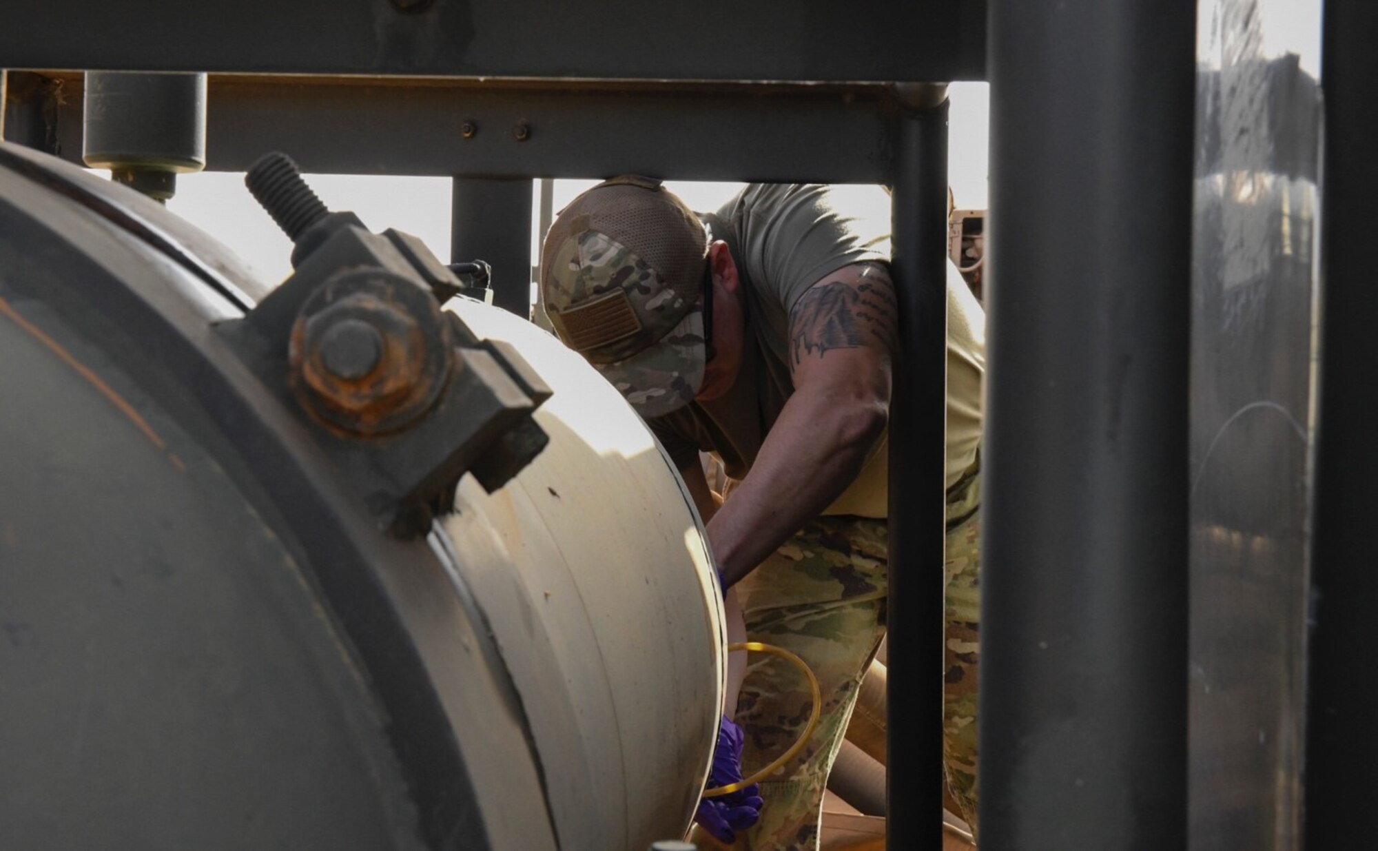U.S. Air Force Staff Sgt. Justin Sabala, 768th Expeditionary Air Base Squadron fuels laboratory/logistics readiness flight noncommissioned officer in charge, pulls fuel from a fuel tank to test its quality at Nigerien Air Base 101, Niamey, Niger, Feb. 15, 2021. Sabala tests fuel quality any time Air Base 101 receives fuel. (U.S. Air Force photo by Senior Airman Gabrielle Winn)