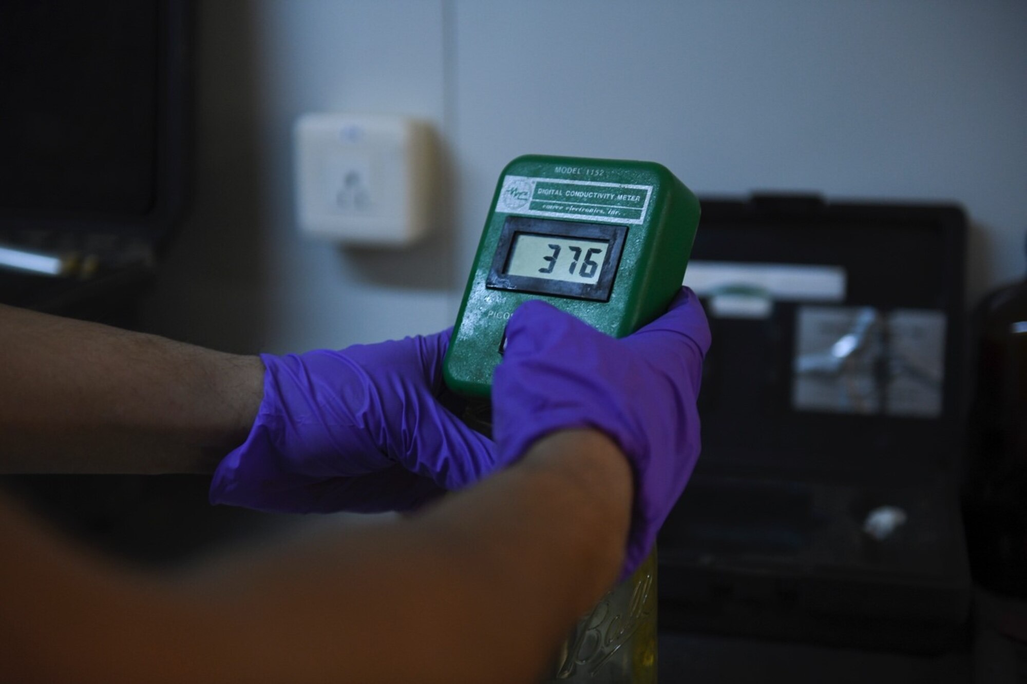 U.S. Air Force Staff Sgt. Justin Sabala, 768th Expeditionary Air Base Squadron fuels laboratory/logistics readiness flight noncommissioned officer in charge, uses a digital conductivity meter to test the level of additive in a sample of jet fuel at Nigerien Air Base 101, Niamey, Niger, Feb. 15, 2021. Testing fuel samples ensures that the petroleum, oil and lubricant section is servicing aircrafts with high quality jet fuel. (U.S. Air Force photo by Senior Airman Gabrielle Winn)