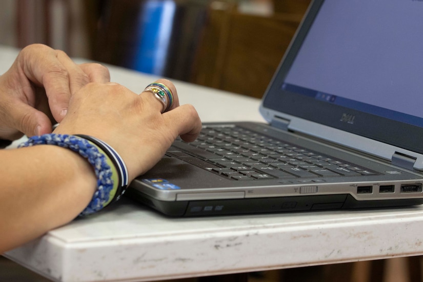 A person types on a keyboard.