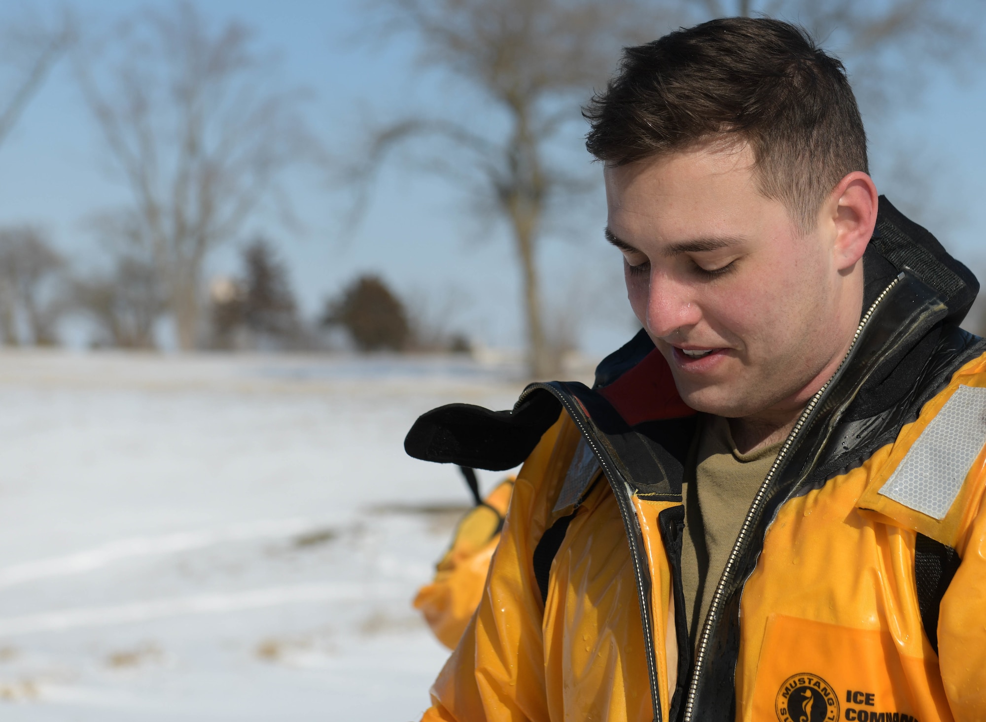 Senior Airman Jackson Bird Stands at a base lake during cold weather training.