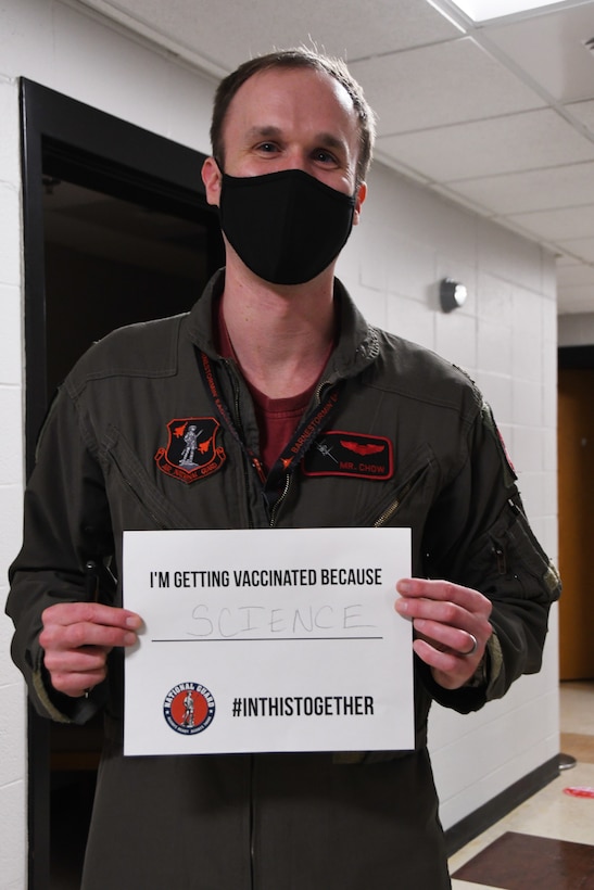 U.S. Air Force Maj. Mark 'Mr. Chow' Silvers, a pilot with the 131st Fighter Squadron, poses for a photo after receiving his COVID-19 vaccination at the base clinic Feb. 5, 2021. Barnestormers have been stepping up to fight the COVID-19 pandemic by volunteering to get vaccinated.(U.S. Air National Guard photo by Staff Sgt. Hanna Smith)