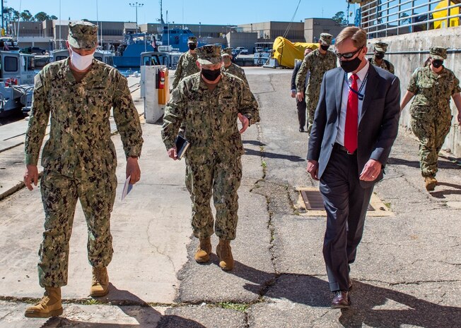 Capt. David Back (left), commanding officer at Naval Surface Warfare Center Panama City Division (NSWC PCD) and Dr. Peter Adair (right), NSWC PCD technical director provide a tour of unmanned systems with Adm. Mike Gilday, Chief of Naval Operations (center) March 4.