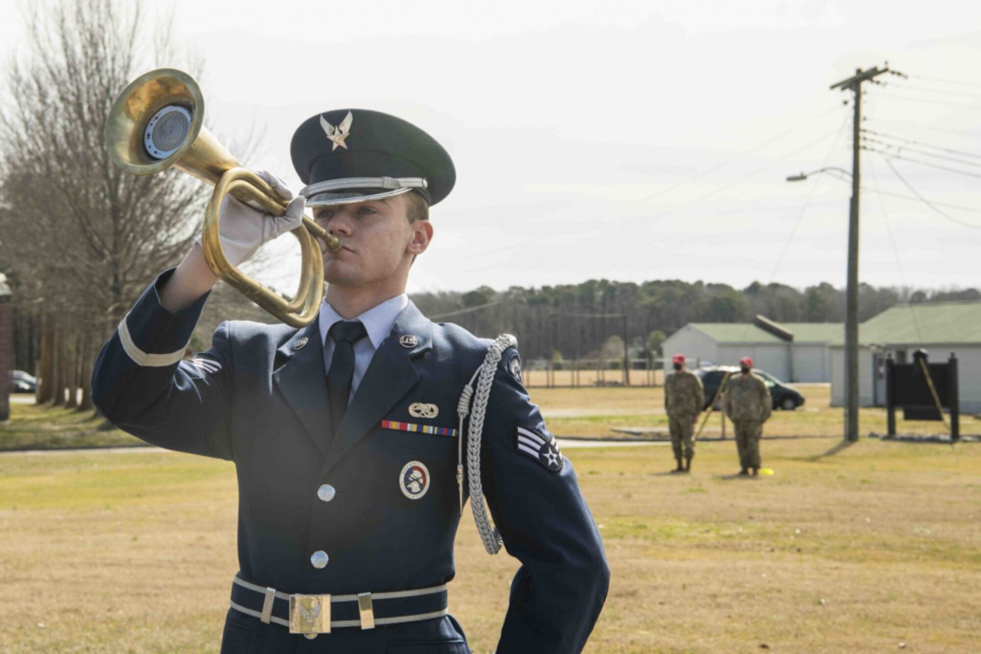 An Honor Guard Airman plays Taps on the trumpet
