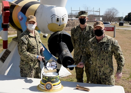 As we honor the Construction Battalion today, Navy Expeditionary Combat Command, NECC, Heaquarters celebrated with a cake cutting and singing of the Seabee song. L to R Lt. Dylan Berns, Capt. Richard Hayes and CUCM Michael ‘Shane’ Jenkins.