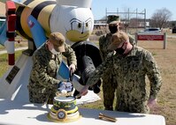 As we honor the Construction Battalion today, Navy Expeditionary Combat Command, NECC, Heaquarters celebrated with a cake cutting and singing of the Seabee song. L to R Lt. Dylan Berns, Capt. Richard Hayes and CUCM Michael ‘Shane’ Jenkins.