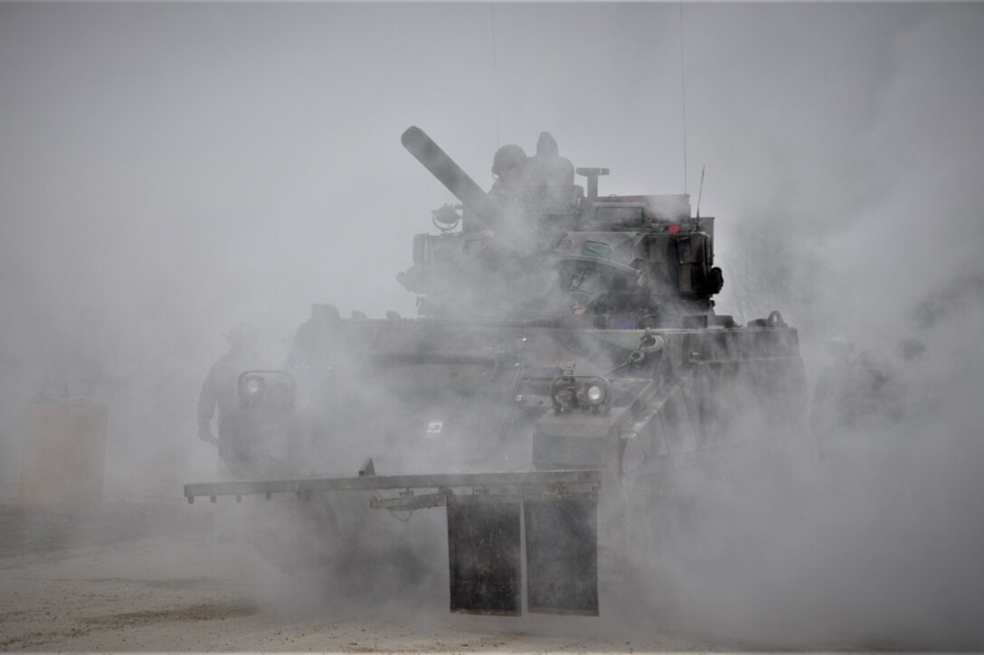Soldiers in a tank take part in a NATO-led exercise.