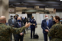 U.S. Secretary of Homeland Security Alejandro N. Mayorkas, left, and Jim F. Kenney, mayor of Philadelphia, right, receive a brief from the Combat Logistics Battalion 22 (CLB-22) staff during the soft launch of the state-run, federally-supported  Center City Community Vaccination Center at the Pennsylvania Convention Center in Philadelphia on Mar. 2, 2021.