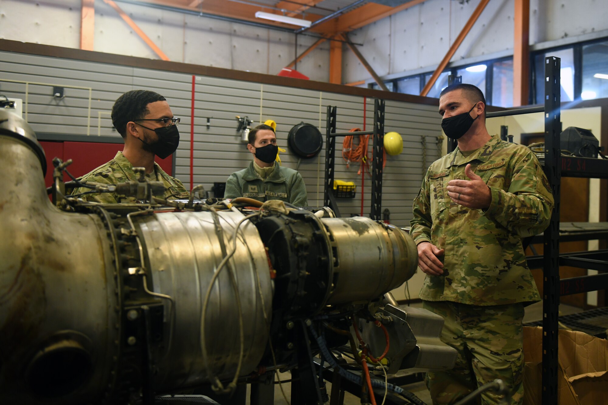 Senior Master Sgt. Matthew Parker, 349th Maintenance Group quality assurance superintendent, right, explains components and operation of an auxiliary power unit gas turbine compressor to Airmen assigned to Beale Air Force Base, Feb. 16, 2021, at Travis Air Force Base, California. The Airmen visited Travis to learn about the various components on different types of aircraft. (U.S. Air Force photo by Airman 1st Class Luis A. Ruiz-Vazquez)