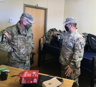 Lt. Gen. Doug Gabram (left), commanding general of Installation Management Command, speaks to a Soldier in the barracks at Fort Hood after a historic winter storm damaged the garrison. IMCOM is leading the recovery effort.