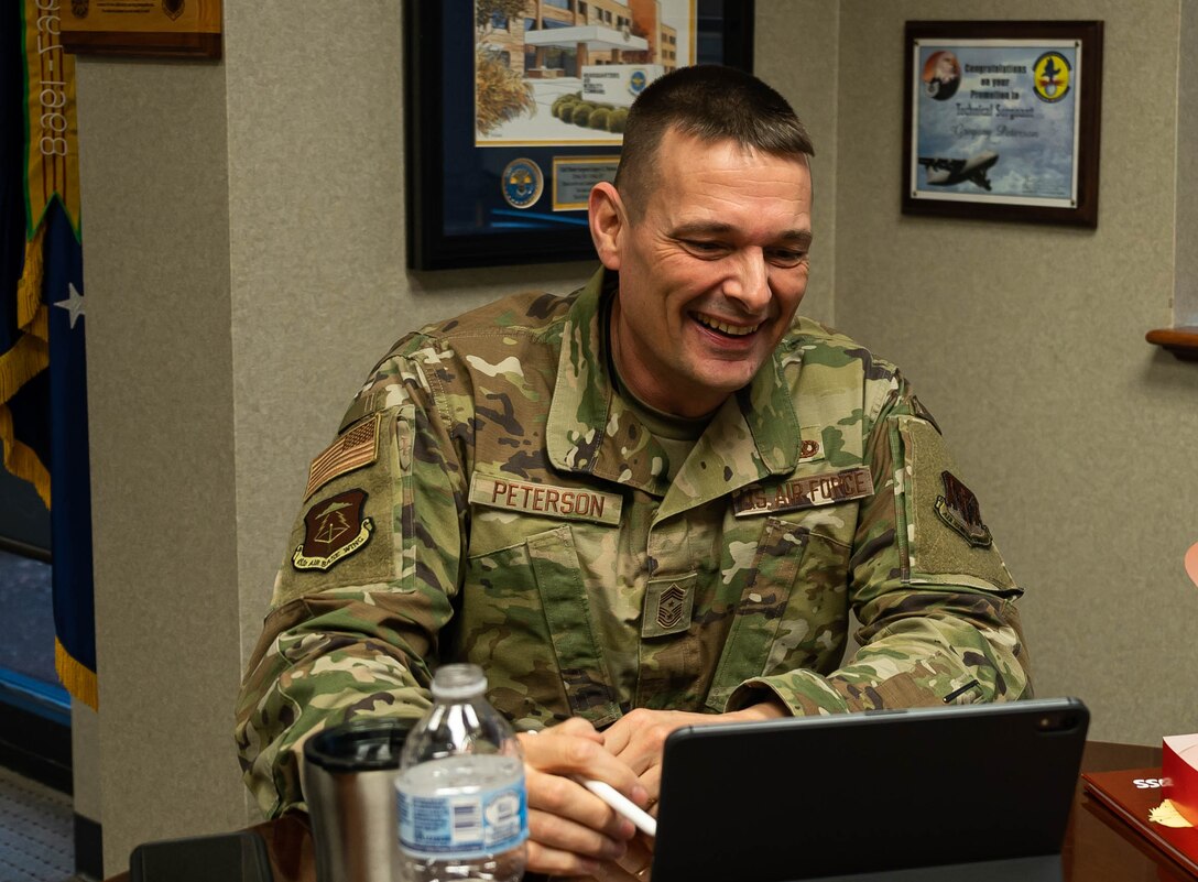 An Airman speaks to students via video chat.
